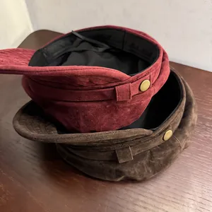 Vintage suede newsboy hats in burgundy and brown with elegant gold button details