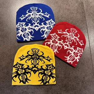 Ethnic style knitted beanie with gothic cross pattern in blue, red, and yellow colors