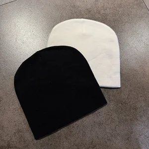 Detailed knit texture and jacquard pattern on black and white beanies set