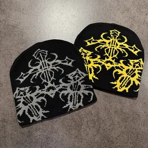 Close-up of black knit beanie with ethnic jacquard pattern in grey and yellow colors