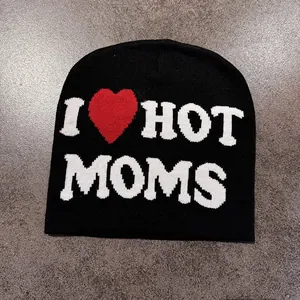 Detail showing the intricate jacquard knitting of the black I Heart Hot Moms beanie hat