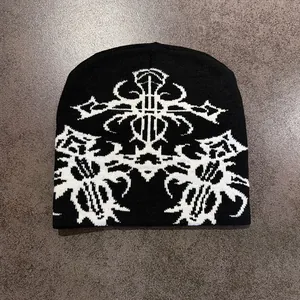 Close-up of black beanie with white ethnic jacquard pattern and gothic totem knitting