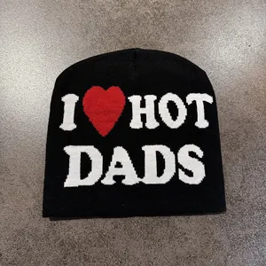 Close-up of black knit beanie with woven I Love Hot Dads text and red heart graphic