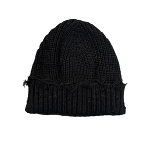 Distressed black knit beanie with frayed edges for men and women in hip-hop street style