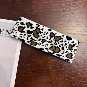 Close-up of knitted cow pattern sports headband with soft texture and tight stitching