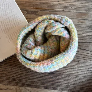 Colorful thick knit snood scarf in pastel macaron shades with warm texture