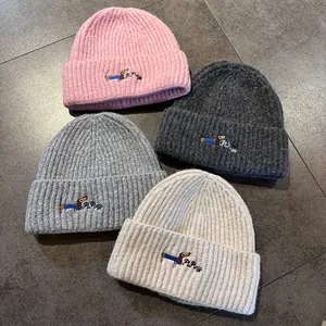 Knit beanie hat featuring embroidered dachshund pattern in four stylish colors
