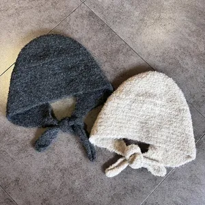Winter knitted balaclava hats in dark grey and beige colors with self-tie straps