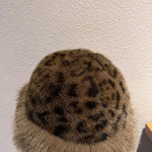 Close-up of fluffy faux fur texture and leopard print pattern on warm winter hat