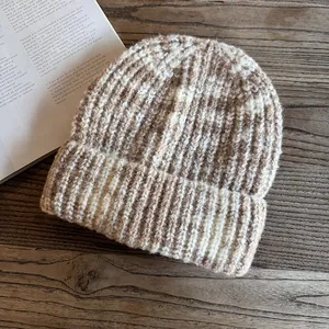 Detailed close-up of thick ribbed knit texture on a brown and beige marbled beanie