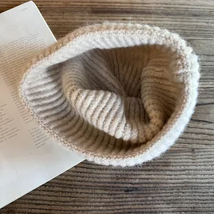 Close-up of beige ribbed knit beanie featuring soft fluffy texture and premium wool material