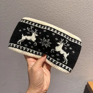 Detail of deer and snowflake jacquard knit pattern on the warm winter wide headband