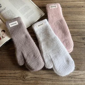 Winter faux rabbit fur mittens in pink, white, and brown with stylish woven fashion labels