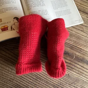 Fuzzy vibrant red rabbit fur gloves with white polka dots for winter warmth