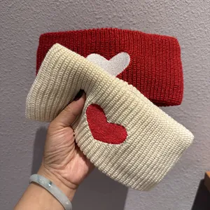 Winter knitted headband set with contrast heart patterns in red and cream colors