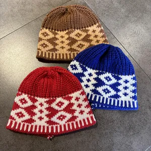 Detail showing thick geometric jacquard knit texture on three colorful winter hats