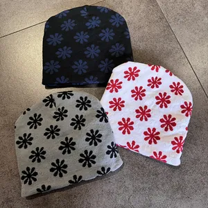 Three colorful knit beanies with daisy floral patterns for warm outdoor streetwear fashion