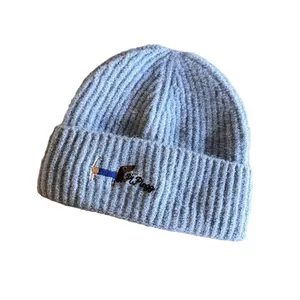 Light blue knit beanie with dog embroidery and warm ribbed texture for winter wear