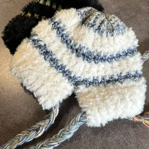 Plush winter earflap hat for women with warm faux fur and thick knit striped design