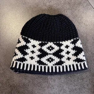 Detail of vintage knitted fisherman hat with black and white Nordic geometric patterns