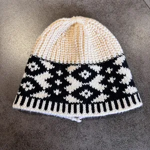 Close-up of vintage knit beanie with geometric jacquard pattern and thick texture