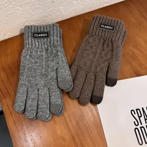 Detail of warm knitted gloves with touchscreen fingertips and classic ribbed cuffs