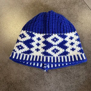 Detailed close-up of blue and white geometric knit pattern on a warm winter beanie hat