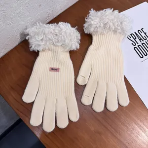 Detail of cream knit gloves with faux fur trim and touch screen finger openings