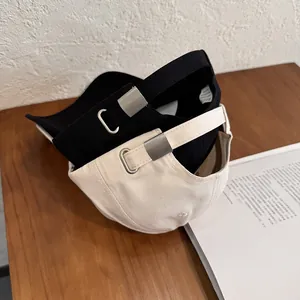 Black and beige minimalist cotton baseball caps with heart embroidery and metal buckles