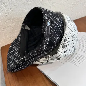Detail of dachshund embroidery and silver button on striped newsboy cap for women
