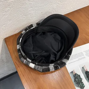 Retro plaid newsboy cap with black leather brim and adjustable lining drawstring