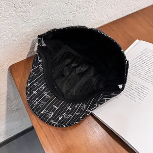 Black striped ivy cap with puppy embroidery on a vintage wooden table setting
