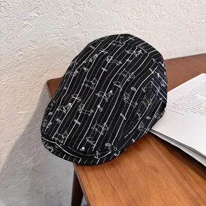 Detail of a black striped flat cap featuring a small dachshund cartoon embroidery