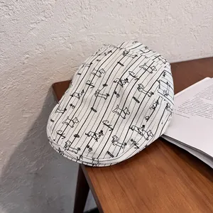 Close-up of white striped ivy cap featuring dachshund patterns and sinking embroidery