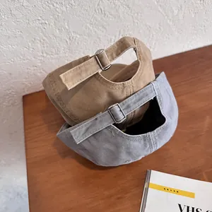 Vintage washed canvas baseball caps in khaki and blue with adjustable metal buckles