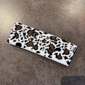 Close-up of knitted cow pattern headband showing detailed texture and high-quality weave
