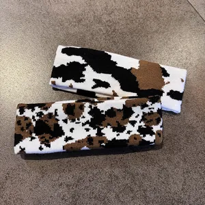 Knitted cow print headbands for sports and casual wear in black and brown patterns