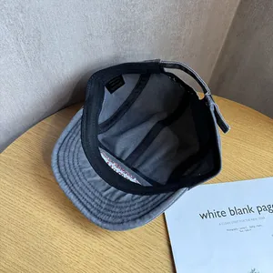 Detail view of the 100% cotton inner lining and sweatband of the dark gray camper cap