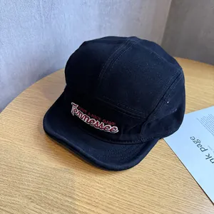 Detail of premium black cotton 5-panel cap featuring white Tennessee script embroidery