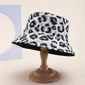 Detailed view of leopard print bucket hat with textured fabric on a wooden stand