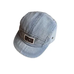 Fashion light blue denim camper cap with metal ring detail on a front square patch