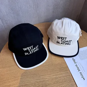 Flat brim 5-panel baseball caps with West Coast Skating embroidery on wood background