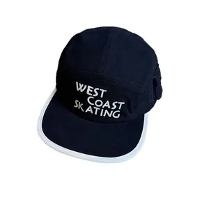 Retro black five-panel camper hat with white brim and West Coast Skating embroidery