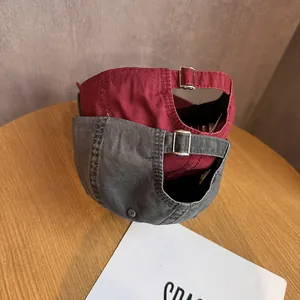 Washed cotton baseball caps in burgundy and dark gray with adjustable metal buckles