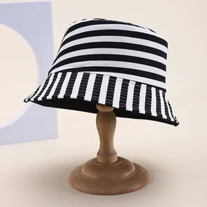 Classic striped bucket hat with reversible design on vintage wooden stand
