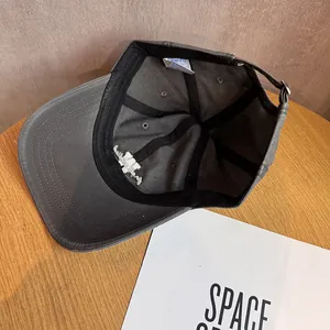 Detailed interior view of a charcoal grey baseball cap with stitching and sweatband