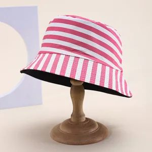 Detail of pink and white striped bucket hat with cotton texture on a wooden stand