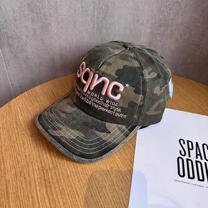 Close-up of pink 3D embroidery on a camouflage baseball cap with durable stitching