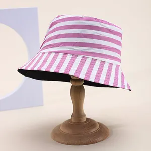 Reversible striped sun hat in pink and white with flat top and wide brim for summer