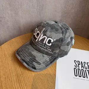 Detailed close-up of grey camo baseball cap featuring premium 3D white embroidery